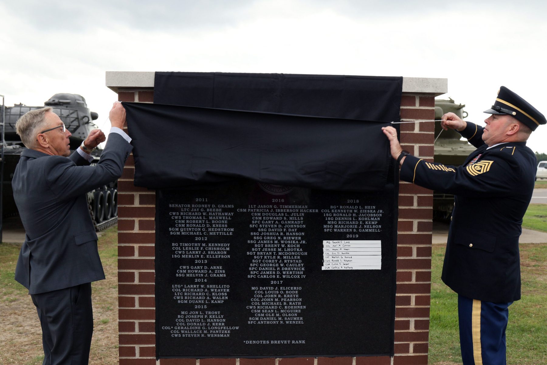 Maj. Gen. (Ret.) Elandson, Court of Honor board member, and Command Sergeant Major Erickson unviel the Court of Honor monument near the Military Museum on Camp Ripley on October 6th, 2019