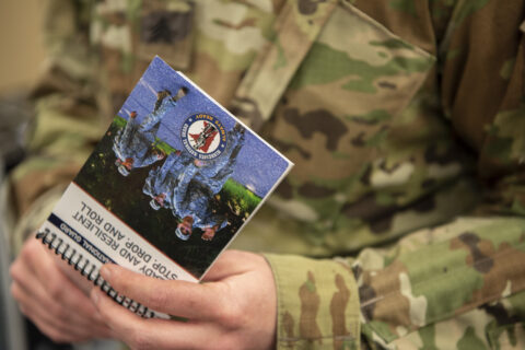A Soldier hold the new Ready and Resilient Program booklet.