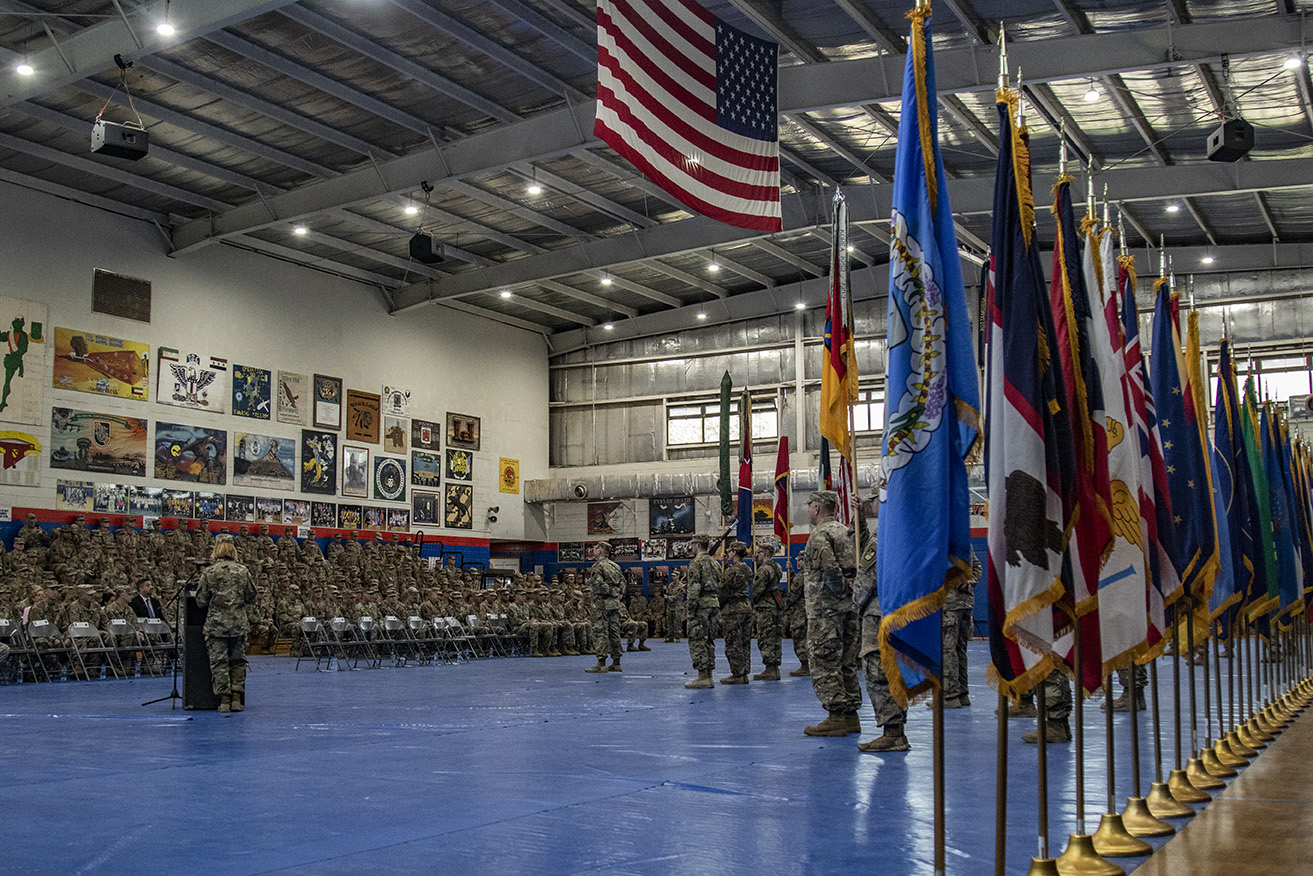 Maj. Gen. Benjamin Corell, 34th Red Bull Infantry Division commanding general and Command Sgt. Maj. Joseph Hjelmstad uncase the Division colors during a transfer of authority ceremony Nov. 12, 2018. The Minnesota National Guard unit's headquarters and headquarters battalion assumed responsibility for the Task Force Spartan mission to from the Pennsylvania National Guard's 28th Infantry Division. The 34th's HHBN is serving as a division headquarters for roughly 10,000 Soldiers conducting theater security operations in the Middle East. (U.S. Army photo by Sgt. William Boecker)