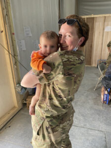A Minnesota National Guard Soldier holds a baby.